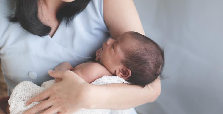 Mother holding newborn child