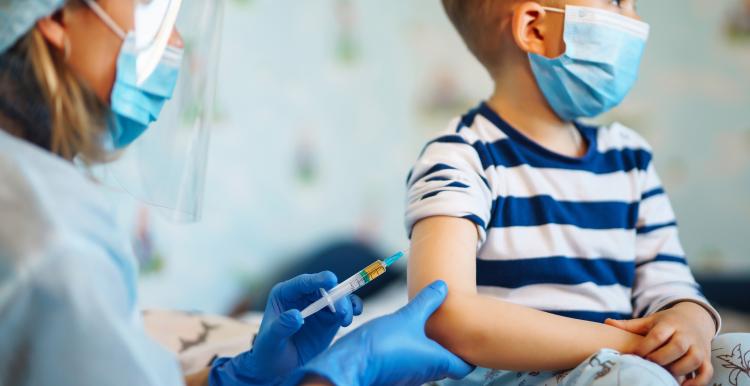 Boy with measles recieving vaccine