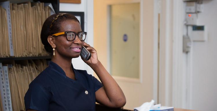 A receptionist on the phone in a hospital