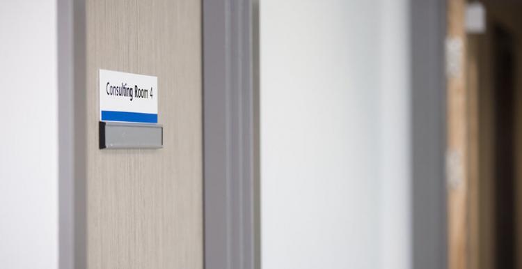 Hospital door with a sign saying consultation