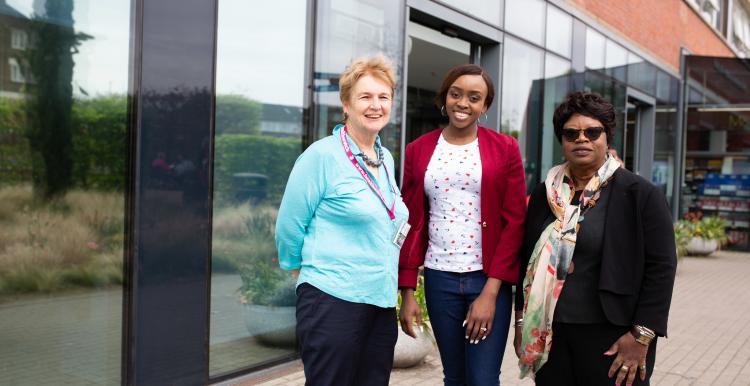 Three women outside hospital entrance