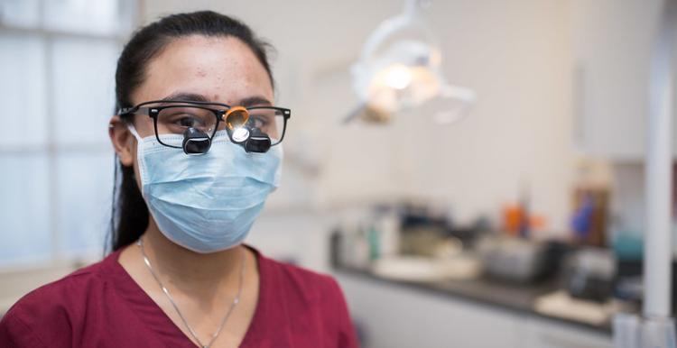 photo of female dentist wearing a mask