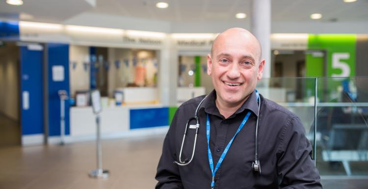 male doctor standing in doctors surgery