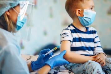 Boy with measles recieving vaccine