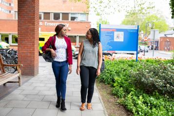 Two females walking outside an accident and emergency department