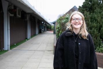 Young girl standing outside smiling