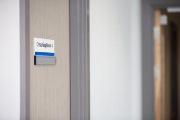 Hospital door with a sign saying consultation