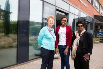 Three women outside hospital entrance