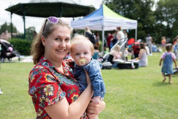 A mother and baby looking at the camera