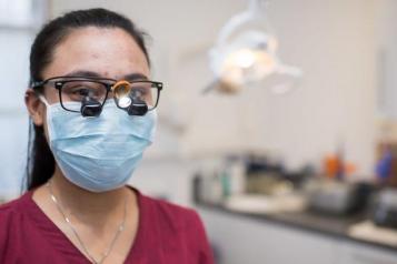 photo of female dentist wearing a mask