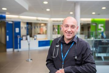 male doctor standing in doctors surgery