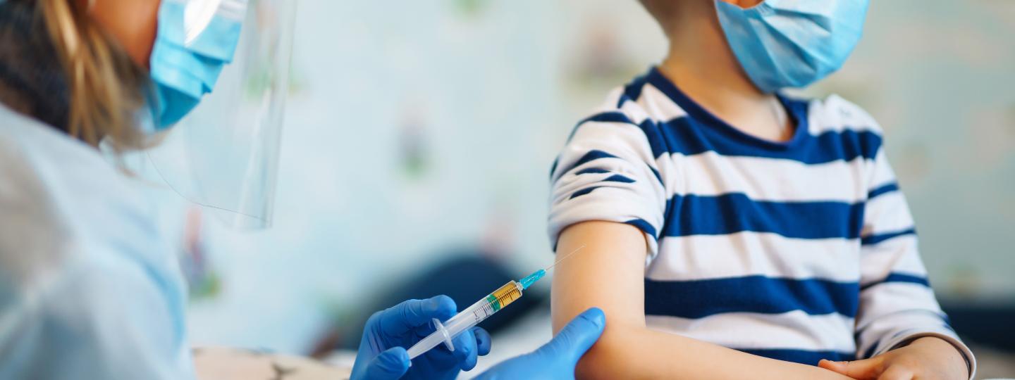 Boy with measles recieving vaccine