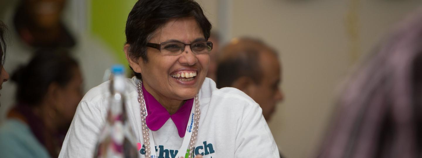 Woman smiling at healthwatch event
